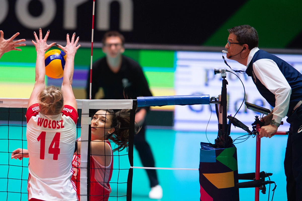Volleyball referee reviewing a difficult decision using video challenge technology